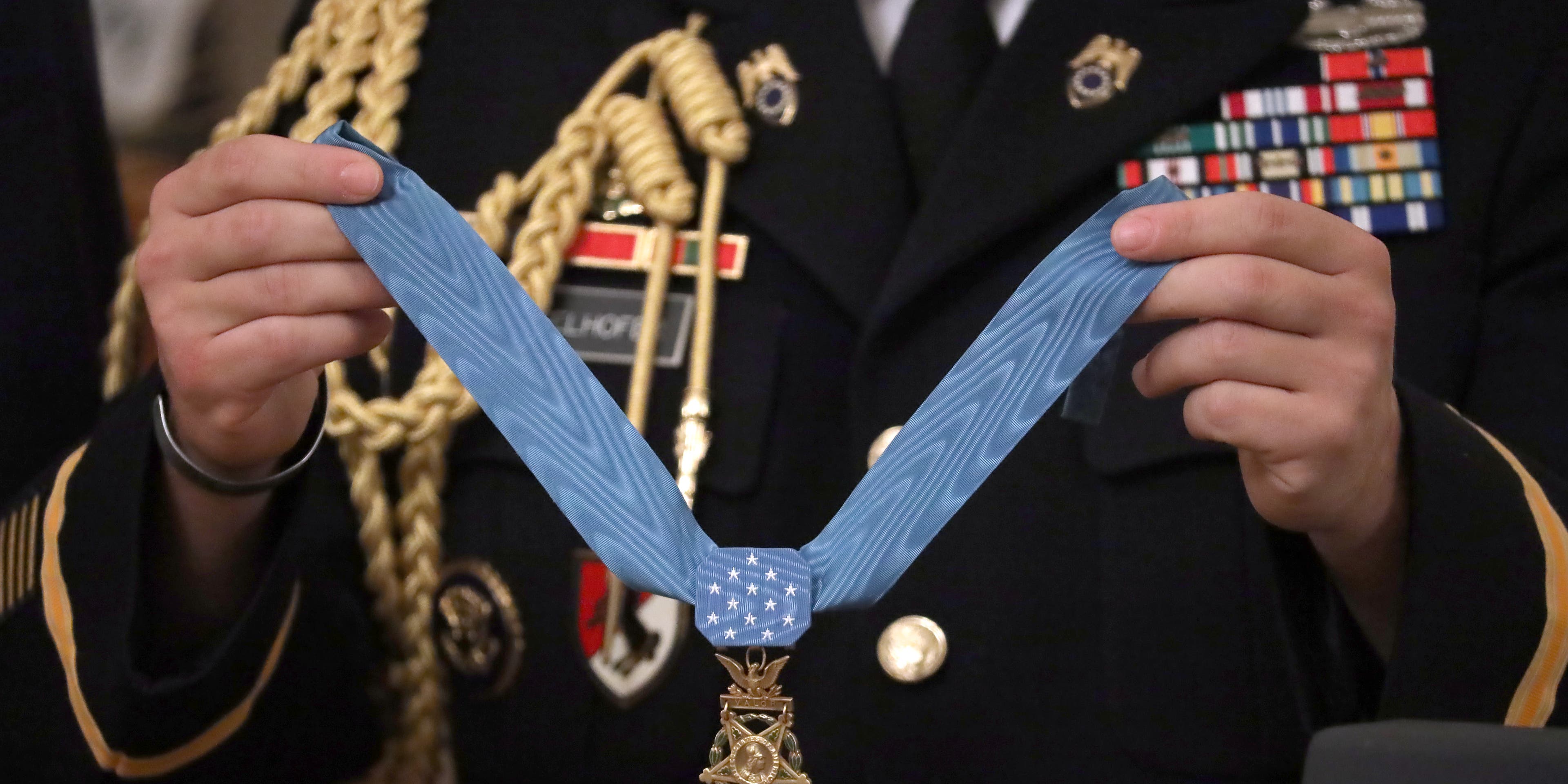 WASHINGTON, DC - OCTOBER 30: A military aide holds U.S. Army Master Sgt. Matthew Williams' Medal of Honor during a ceremony in the East Room of the White House October 30, 2019 in Washington, DC. Serving with Special Forces Operational Detachment Alpha in Afghanistan's Shok Valley in 2008, Williams repeatedly risked his life to evacuate four wounded teammates and lead counterassaults after they were pinned down by enemy fire during a mission to capture or kill high-value targets. (Photo by Chip Somodevilla/Getty Images)